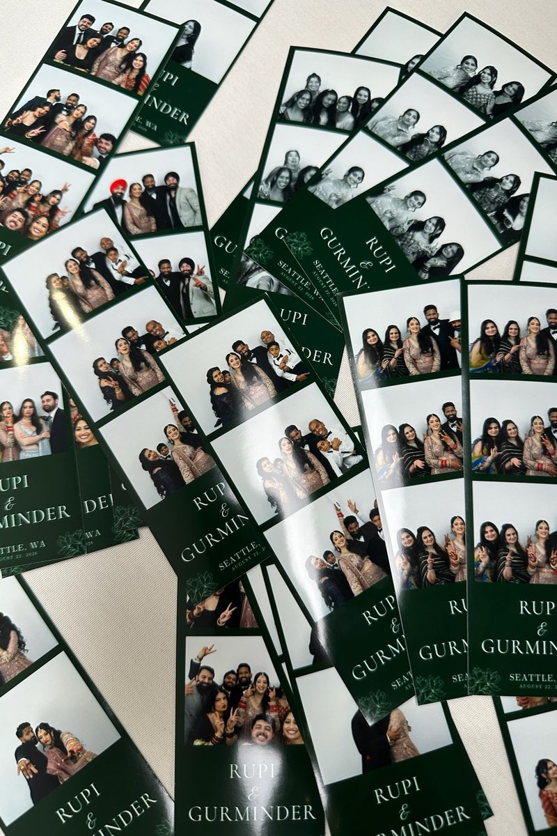 A pile of printed strips from the reception, each with the couple's names in white on green